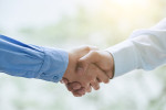 Business partners shaking hands to confirm the deal